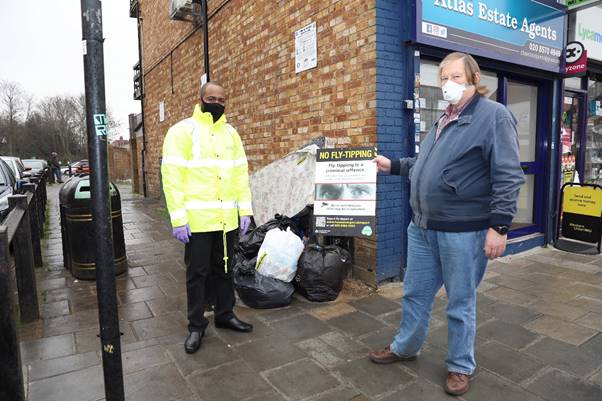 Guy Lambert pointing at bin bags