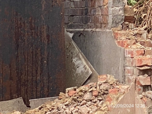 Exposed walls which residents say may contain asbestos 