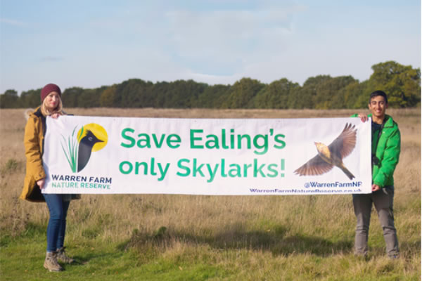 Campaigners with a banner on Warren Farm