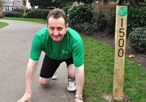 Councillor Julian Bell besides the 1500m distance marker in Lammas Park.