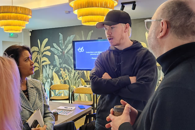 Will Poulter talks to attendees at the round table event 